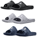 Three pairs of slide sandals are displayed in black, white, and navy colors featuring an arched top design and large cutouts on the upper part for breathability and comfort.