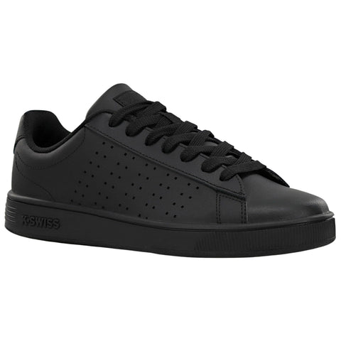 A black sneaker is positioned at an angle displaying its smooth surface and perforated design The shoe features black laces and a logo on the side indicating brand identification