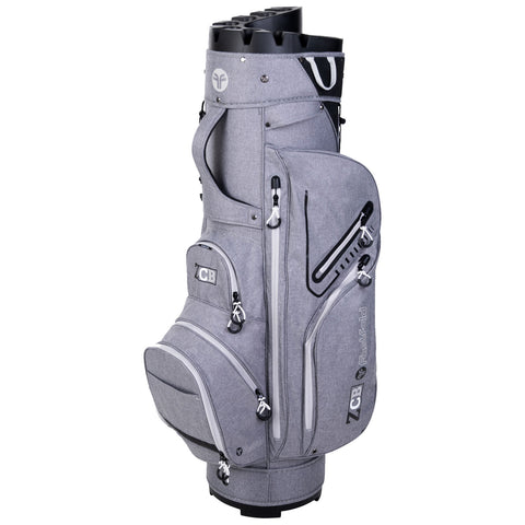 A gray golf bag stands upright showcasing multiple zipped compartments for storing gear and clubs with a sturdy base and molded top for club organization in an outdoor setting.