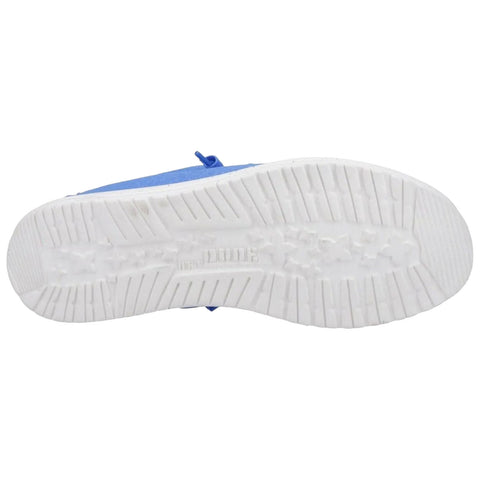 A blue shoe is positioned upside down revealing its white, textured sole featuring treads designed for grip and traction showing a clean surface in a neutral background.