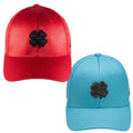 Two baseball caps are displayed side by side. The left cap is red with a black four-leaf clover emblem while the right cap is light blue also featuring a black four-leaf clover emblem.