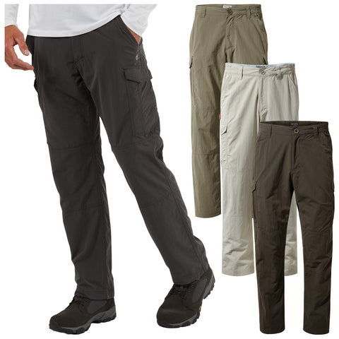 Cargo pants in various colors are displayed with one pair being worn by a person standing and extending a hand. The background is plain highlighting the clothing.