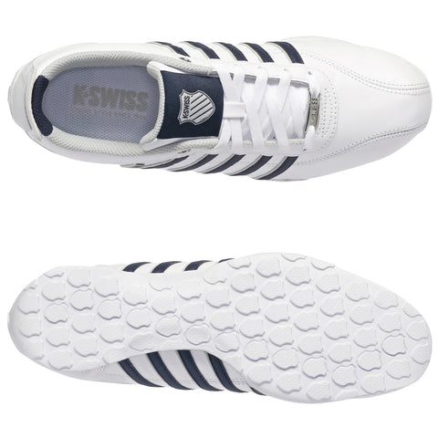 White athletic shoes with navy stripes are positioned facing upward. They feature a textured sole and laces, suitable for sports activities in a neutral indoor setting.