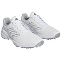 White athletic shoes are positioned side by side showcasing their sleek design and contrasting grey accents made for sports use in various outdoor environments