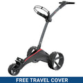 A golf trolley stands upright with large wheels and a handle positioned for pushing. It is situated against a plain background featuring a blue banner stating FREE TRAVEL COVER.