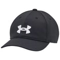 A black baseball cap features a white Under Armour logo in front resting on a flat surface with a smooth texture and a rounded top designed for casual wear and sun protection.