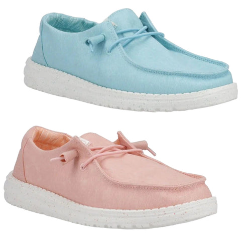 Two pairs of casual shoes are displayed one light blue and one light pink both with rounded toes and soft fabric uppers resting on white speckled soles suggesting a relaxed and playful style