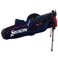 A blue and black golf stand bag displays the brand name Srixon prominently. It features a shoulder strap and a leg stand, suitable for carrying golf clubs on the course.