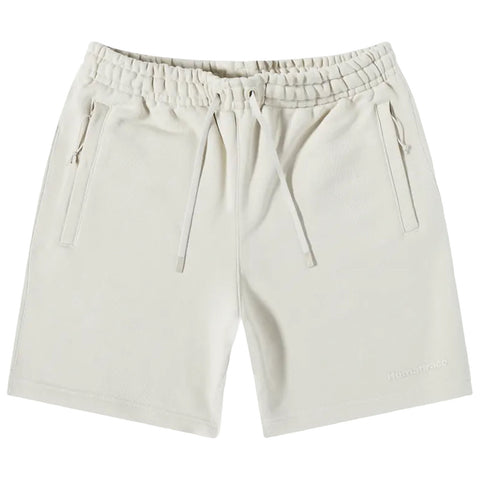 Light-colored shorts made of soft fabric are displayed flat. They feature an elastic waistband with a drawstring and side pockets. The brand name is subtly printed on the leg.