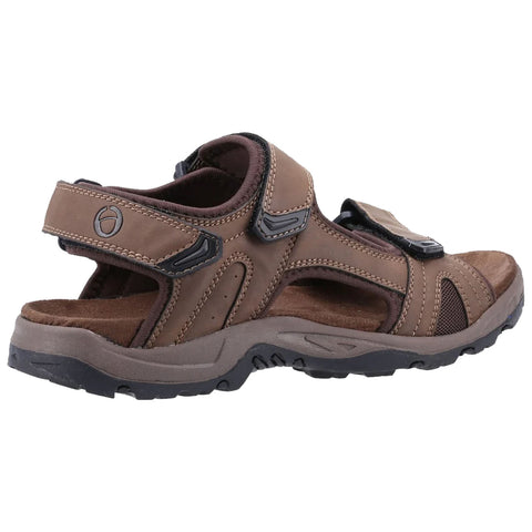 A brown sandal features adjustable straps and a sturdy sole designed for comfort and support in outdoor settings providing breathability and ease of wear during activities like hiking or walking.