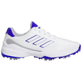 A white athletic shoe is displayed prominently featuring blue accents and three distinctive stripes. The shoe is designed for sports with a textured sole suitable for traction on grass or turf.