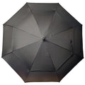 A black umbrella is positioned open with its canopy fully extended providing shade or shelter against rain in an unspecified outdoor environment.