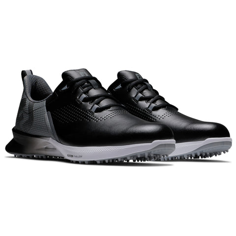 Black golf shoes are displayed side by side with a smooth leather upper and a textured heel. They have a white sole with spikes for grip on the turf.