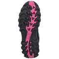 A black and pink athletic shoe sole with a rugged tread pattern is positioned upward showcasing its grip features designed for traction on various terrains.