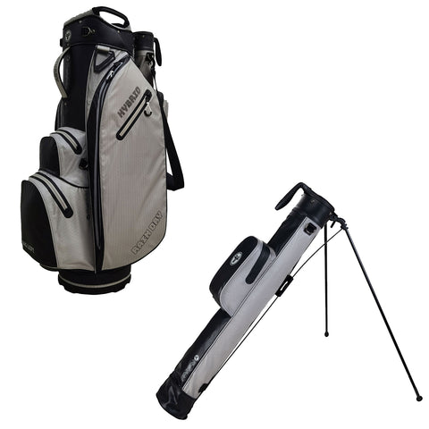 A gray and black golf bag is positioned upright with multiple pockets and a handle while a smaller stand bag leans on its legs beside it in an undefined space.