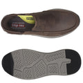 A brown slip-on shoe is displayed with a textured gray sole underneath showcasing a cushioned insole labeled air cooled memory foam suitable for casual wear in various settings.