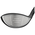 A golf club head with a sleek black finish features a grid-like textured surface for impact. It's designed for precision shots on a golf course.