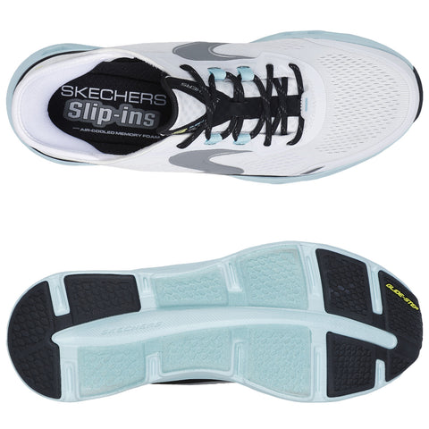 A athletic shoe is displayed with a white mesh upper and black laces resting flat. The context shows the shoe's sole design featuring different textures for grip and cushioning. The insole reads "SKECHERS Slip-ins AIR-COOLED MEMORY FOAM."