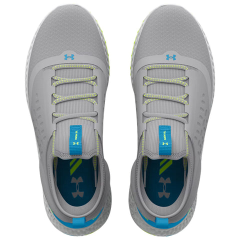 Gray athletic shoes are positioned on a flat surface laces are threaded through eyelets and the tongue features a blue tab with branding the interior shows contrasting colors and logo.