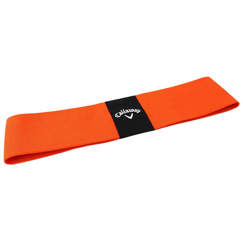 An orange resistance band lies flat on a surface displaying a black logo in the center it is designed for strength training or physical rehabilitation purposes.