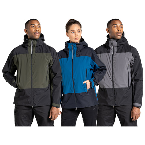 Three individuals wear distinct colored jackets featuring color-block designs. They stand side by side, looking away from the camera against a plain white background.