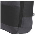 A black backpack is positioned sideways revealing its textured surfaces and mesh panel designed for ventilation showcasing a modern and functional style suitable for travel or daily use.