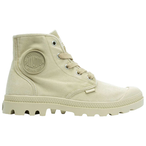 A beige high-top boot is displayed upright showcasing its canvas material and rubber sole featuring a distinctive textured pattern and a circular logo on the side indicating the brand name.