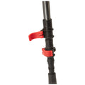 A black adjustable pole with red locking mechanisms is shown positioned vertically. The red clips are engaged to secure different heights, indicating its use for stabilization or support in various activities.