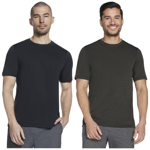 Two men are posing side by side wearing t-shirts one in black and one in dark green with grey shorts in a plain white background. Both display neutral expressions.