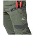 A pair of olive green work pants features a pocket holding red-handled tools with a logo that reads Hard Yakka on the side showcasing durable construction for heavy-duty tasks.