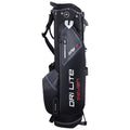 A black golf bag stands upright showcasing various compartments and zippers for storage. It features branding on the side and is equipped with a carrying strap for mobility.