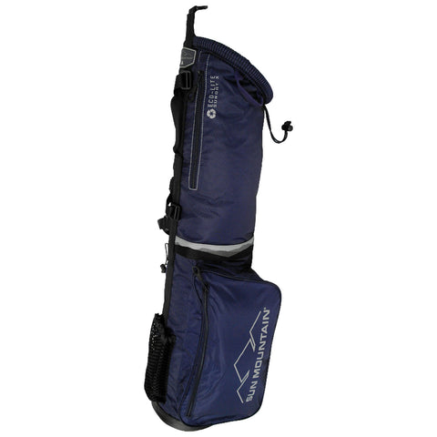 A navy blue golf bag stands upright displaying a cylindrical upper section and a side pocket featuring the logo Sun Mountain with a mesh pocket for additional storage in an outdoor setting