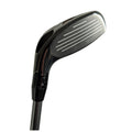 A golf club head is shown positioned at an angle with a shiny metal surface and alignment grooves indicating precision. The club is part of golf equipment used for playing on grassy courses.