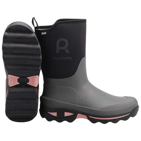 A pair of gray rubber boots features a textured black sole with pink accents positioned upright on a flat surface showcasing a smooth design and a brand logo on the side