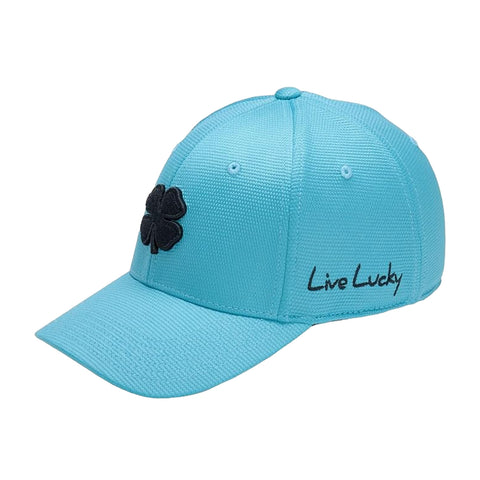 A light blue baseball cap features a black four-leaf clover logo on the front and the phrase Live Lucky embroidered in black on the side, resting on a flat surface.