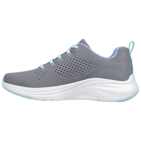 A grey athletic shoe with light blue laces and accents is positioned sideways showing its mesh upper and rounded sole designed for comfort and support in active environments.