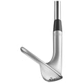 A golf club lies horizontally showcasing its polished silver head and black grip while positioned for a shot on a golf course or practice area highlighting its elegant design and functionality.