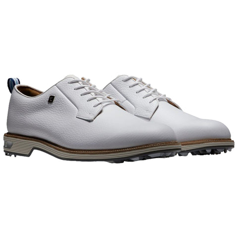 White golf shoes are positioned side by side they feature a textured leather upper and a lace-up design with a contrasting blue and white pull tab at the back