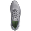 Gray athletic shoe with a textured upper and white sole rests flat on a surface showcasing its sleek design and lacing system with green insole displaying the word LIGHTST.