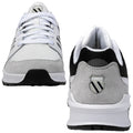 A pair of athletic shoes is displayed with their laces tied showcasing a combination of white mesh and gray suede materials they are positioned against a plain background.