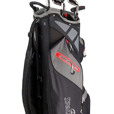 A golf bag stands upright displaying a sleek design with multiple pockets including a labeled dry pocket and several clubs visible at the top against a plain background.