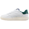 A white sneaker with a textured green heel displays a smooth design featuring laces and a rubber sole resting against a plain background.