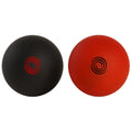 Two exercise balls are positioned side by side one is black with a red swirl design and the other is red with a black swirl design on a plain background