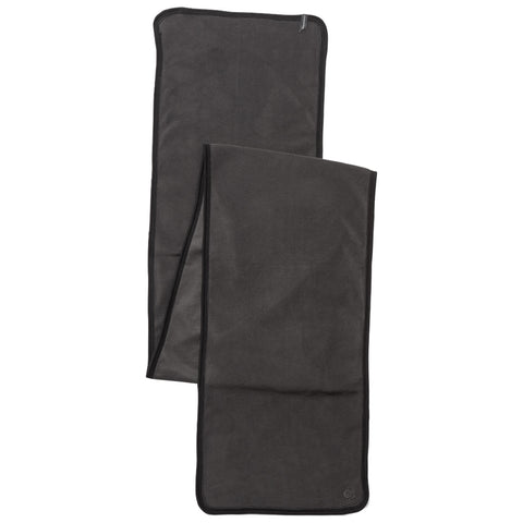 A dark grey towel is spread out flat showcasing its soft texture and bordered edges situated on a plain background ideal for use in various settings such as at the beach or gym