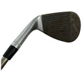 A golf club featuring a silver shaft and a worn clubhead with grooves is positioned at an angle, suggesting readiness for a swing on a golf course.