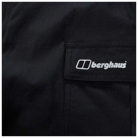 A black fabric garment displays a pocket with the white logo of the brand Berghaus prominently stitched on it, suggesting an outdoor or hiking apparel context.