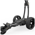 A black golf push cart with large wheels is positioned upright its handle is at a height suitable for pushing it forward on a flat surface.