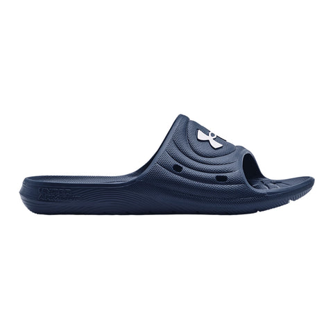 A navy blue slide sandal is displayed in profile showcasing a wide open toe and a circular logo design on the strap with textured patterns on the footbed and sole.