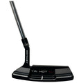 A black golf putter stands upright with a shiny metal shaft and a textured club face featuring the brand name Odyssey and the model name TRI-HOT 5K visible on its side.