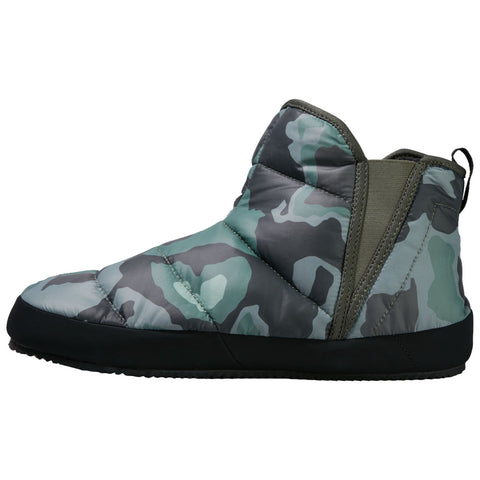 A camouflage-patterned boot is positioned upright showcasing a padded upper and a black sole emphasizing comfort and warmth suitable for colder environments.